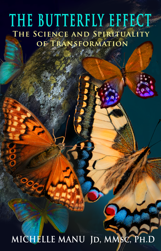 A colorful book cover titled "THE BUTTERFLY EFFECT" in large blue letters at the top, with the subtitle "THE SCIENCE AND SPIRITUALITY OF TRANSFORMATION" below it in smaller blue letters. The cover features a vibrant collage of several butterflies with various wing patterns and colors, predominantly shades of orange, yellow, and blue, set against a dark, blurred background that includes hints of green foliage. At the very bottom of the cover, in white text, is "MICHELLE MANU JD, MMSc, PH.D".