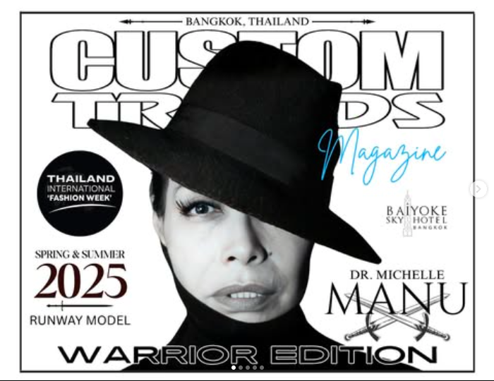 A monochromatic magazine cover for "Custom Trends Magazine" features Dr. Michelle Manu. She is a light-skinned woman with a serious expression, wearing a black fedora hat that casts a shadow over her eyes, and a black turtleneck. Text on the cover includes "BANGKOK, THAILAND", "Custom Trends Magazine" (with "Magazine" in light blue script), "THAILAND INTERNATIONAL 'FASHION WEEK'", "SPRING & SUMMER 2025", "RUNWAY MODEL", "DR. MICHELLE MANU" with two crossed swords below her name, "WARRIOR EDITION", and "BAIYOKE SKY HOTEL BANGKOK". A small scroll indicator at the bottom suggests multiple pages.